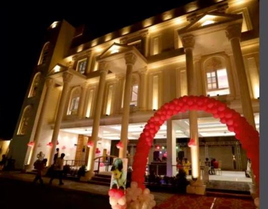 Aarambh Banquet hall exterior at night, lit up for an event